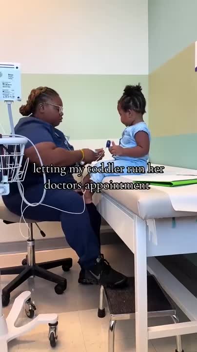Nurse Listens Intently as Toddler Takes Charge of Own Medical Appointment